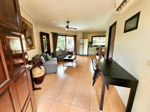 a living room with a couch and a table at Soleil D'asie Residence in Chaweng Noi Beach