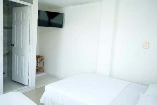 Ένα ή περισσότερα κρεβάτια σε δωμάτιο στο Hotel Rivera Honda