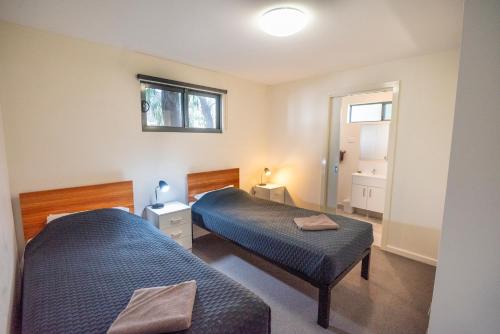a bedroom with two beds and a window at Margaret River Tourist Park in Margaret River Town