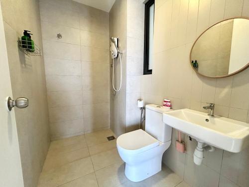 a bathroom with a toilet and a sink and a mirror at Next to BRT station near Sun-Med Sun-Uni & Lagoon in Kampong Penaga