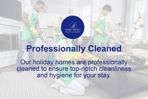 a couple of people cleaning the floor with vacuum cleaners at Amazing Sunset View Penthouse in Auckland