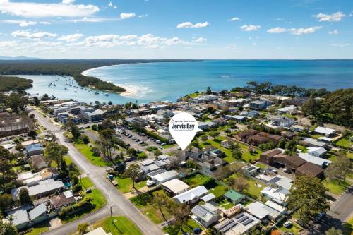 an aerial view of a suburb next to the ocean at Husky Haven by Experience Jervis Bay in Huskisson