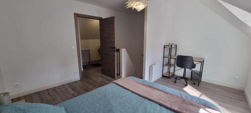 a bedroom with a bed and a chair in it at Maison DEOLS centre 41 pour 1 ou 2 personnes in Déols