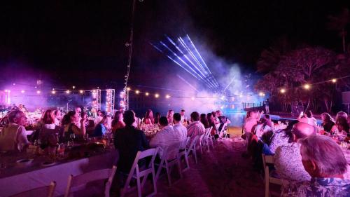 a crowd of people sitting in chairs in front of a stage at InterContinental Sanctuary Cove Resort by IHG in Gold Coast