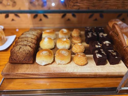 a bunch of different types of pastries on a table at Villa Sirilanna Hotel in Chiang Mai