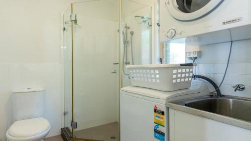 a small bathroom with a sink and a toilet at 9 Reef Terraces Port Douglas in Port Douglas
