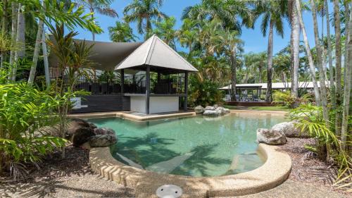 a swimming pool in the middle of a resort at 9 Reef Terraces Port Douglas in Port Douglas