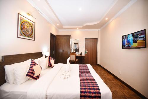 a bedroom with a large white bed in a room at Skye Inn Kathmandu in Kathmandu