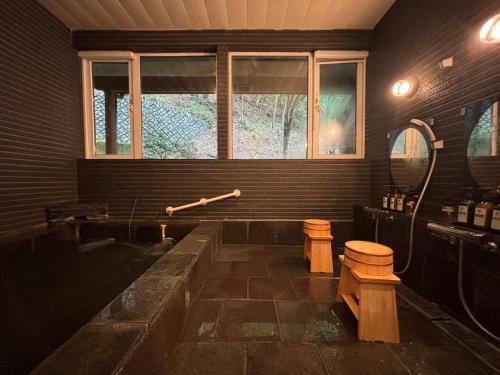 a large bathroom with a tub and a window at オーベルジュ南アルプス in Minami Alps