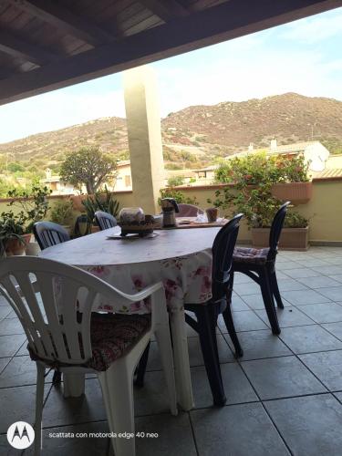 a table and chairs on a patio with a view at B&B Is Pranus a Mari Casa Privata in Solanas