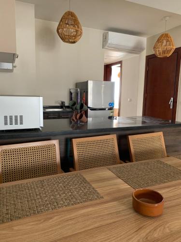 a kitchen with a counter and a table and chairs at Superb Ground floor at Azha Ain Sokhna in Ain Sokhna
