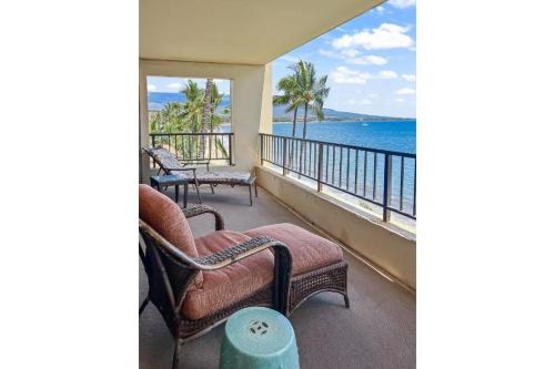 a balcony with chairs and a view of the ocean at SUGAR BEACH RESORT, #540 condo in Kihei