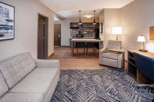 a living room with a couch and a dining room at Candlewood Suites Arundel Mills / BWI Airport by IHG in Hanover