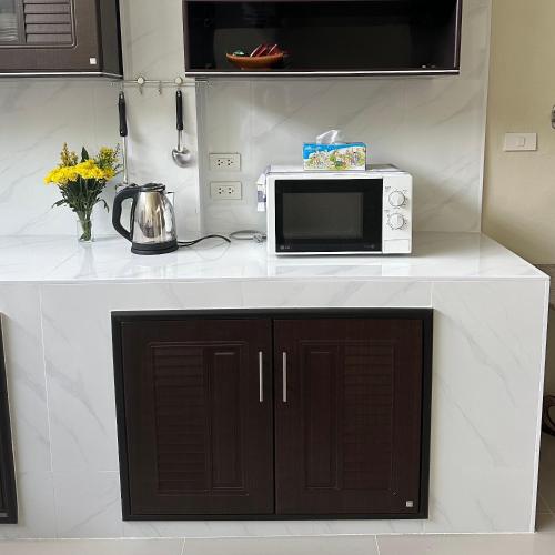 a microwave sitting on top of a kitchen counter at Hatyai house 28 in Hat Yai