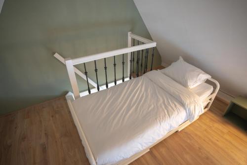 a bedroom with a bed with white sheets at Amersfoort City Center Apartment StadsHart in Amersfoort