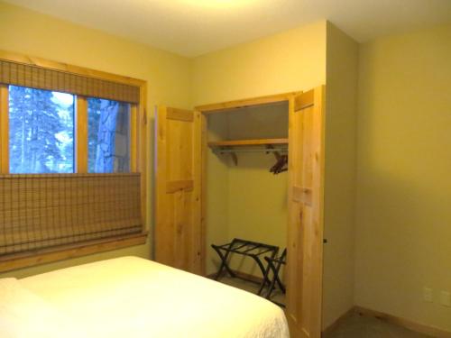 a bedroom with a bed and a window at Luxury Canmore Vacations in Canmore