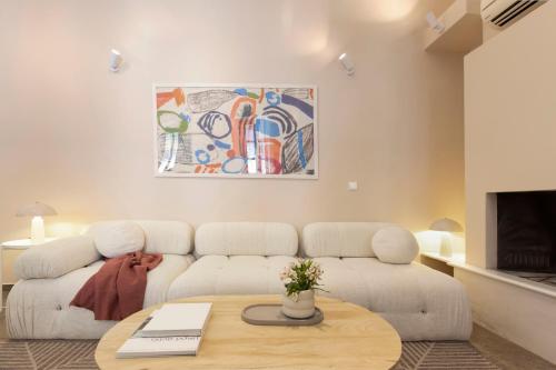 a living room with a couch and a table at Villa Plaka 3BR 9ppl PrivateYard 200m Metro&Museum in Athens