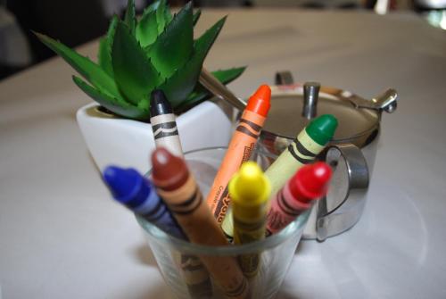 a glass cup filled with pens and pencils on a table at Gariwerd Motel in Halls Gap