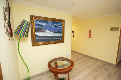 a room with a painting on the wall and a chair at Hotel PAYRO in Santiago de Compostela