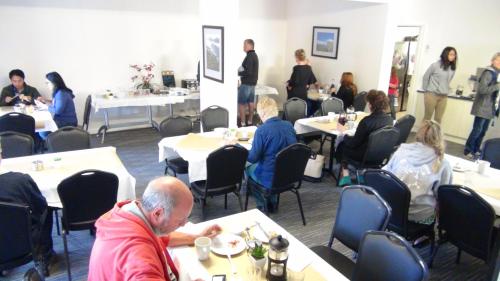 a group of people sitting at tables in a restaurant at Gariwerd Motel in Halls Gap