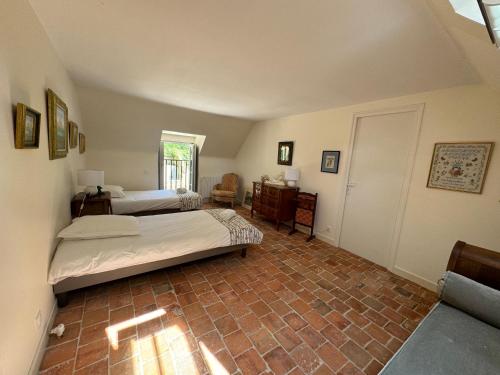 a bedroom with two beds in a room at Gite du Tilleul - Le Petit Bois Martin in Feings