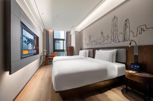 a hotel room with two beds and a tv at UrCove by Hyatt Shenzhen Bay Nanyou in Shenzhen