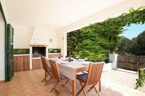 a dining room with a table and chairs at Villa Sa Calma in Port d'Addaia