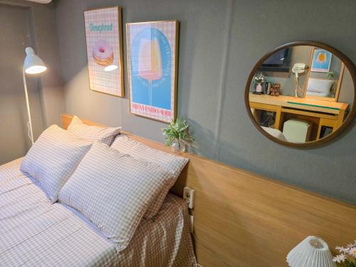 a bedroom with a bed and a mirror at TOP Stay Guro digital complex in Seoul