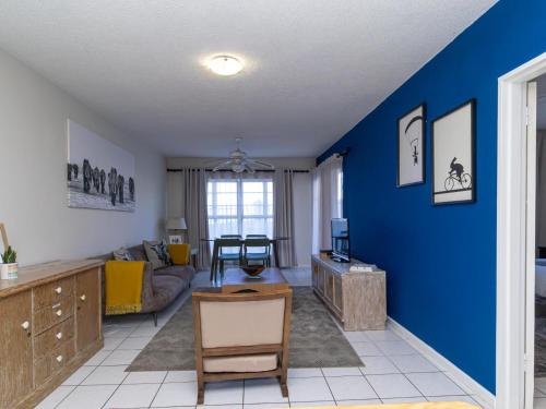 a living room with a blue accent wall at Modern Seaview Apartment in Summerstrand