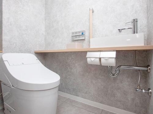 a bathroom with a white toilet and a sink at Kumamoto Hotel Castle in Kumamoto