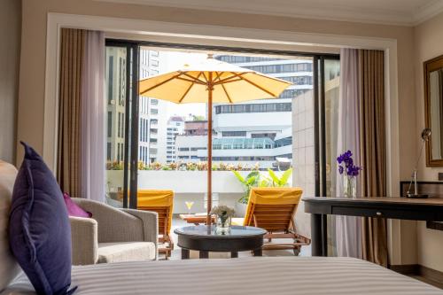 a hotel room with a bed and a large window at NH Bangkok Sukhumvit Boulevard in Bangkok