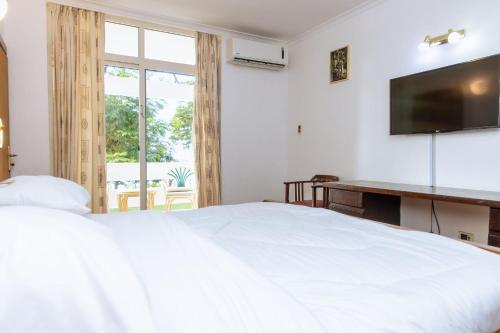 Postel nebo postele na pokoji v ubytování Mkonge Hotel