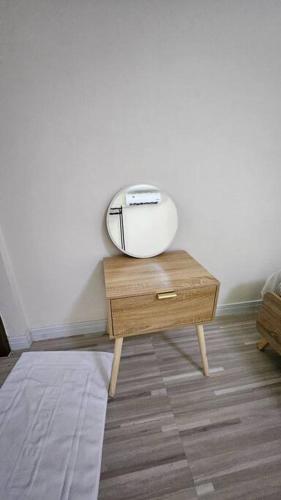a table with a mirror on it in a room at ChiShi House Songkhla in Ban Bang Dan