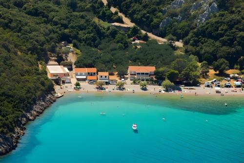 an aerial view of a beach with people in the water at Summer Park Residence Peljesac in Orebić