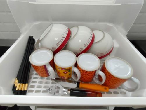 a drawer filled with cups and pens and chopsticks at ChiShi House Songkhla in Ban Bang Dan