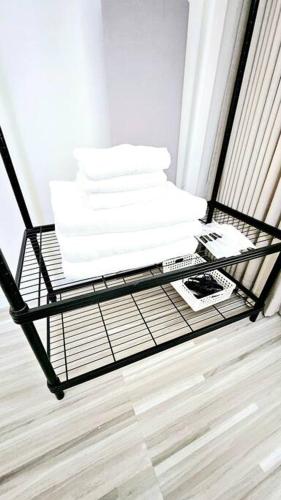 a black shelf with white towels on it at ChiShi House Songkhla in Ban Bang Dan