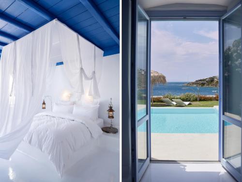 a bedroom with a bed and a view of the ocean at Mykonos Blu, A Grecotel Resort to Live in Psarou