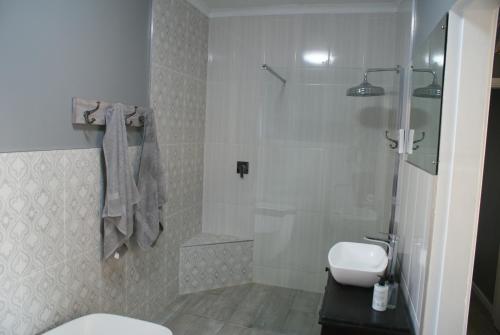 a bathroom with a shower and a toilet and a sink at Sea Vista in Pennington