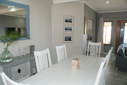 a dining room with a white table and chairs at Sea Vista in Pennington