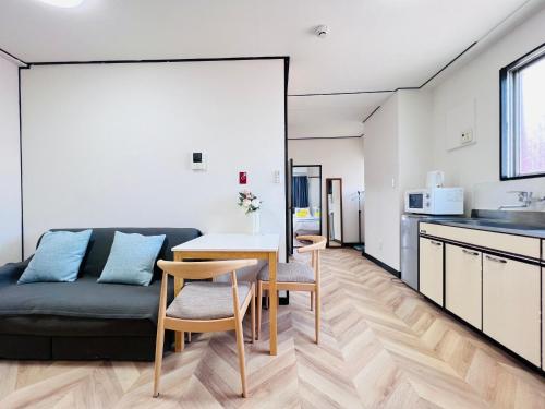 a kitchen and living room with a table and a couch at Shinjuku -JX house SJ0284 in Tokyo