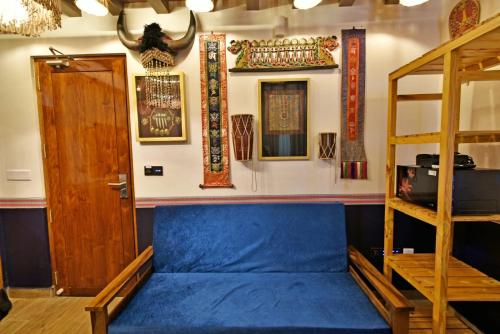 a room with a blue couch and a ladder at Blissful Stay, LUX Suites & Tint of Mint - 1 BHK Apartment, 5min Beach, Auroville Pondicherry in Kottakupam