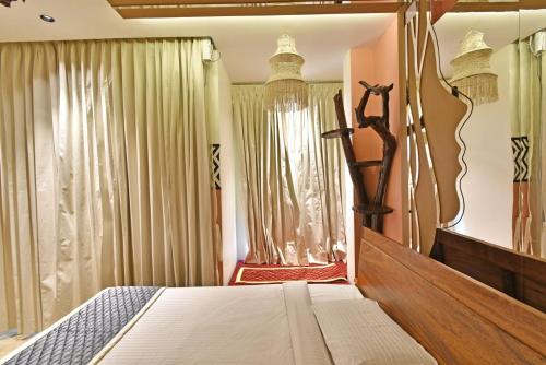 a bedroom with a bed and a window at Blissful Stay, LUX Suites & Tint of Mint - 1 BHK Apartment, 5min Beach, Auroville Pondicherry in Kottakupam