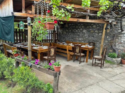a patio with a table and chairs and a table and chairs at Villa Old House BN in Bitola