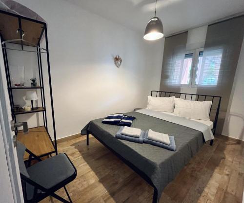 a bedroom with a bed with two towels on it at MDM House in Sutomore