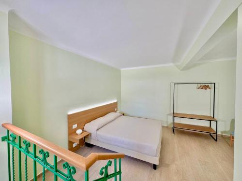 a small bedroom with a bed and a staircase at Bed and Breakfast Casa Castelli - ospitalità e vino in Falerone