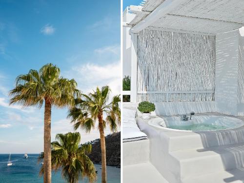 a white building with a bath tub next to a palm tree at Mykonos Blu, A Grecotel Resort to Live in Psarou