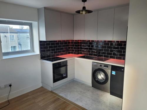 a kitchen with a washer and a washing machine at 2 double bedrooms apartment near airport & town in Dublin