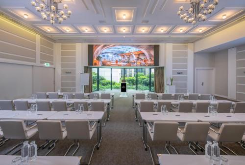a conference room with white tables and chairs at Continental Hotel Budapest in Budapest