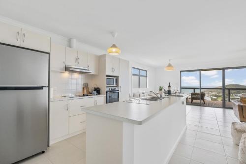 a kitchen with white cabinets and a large counter top at Seaview at the Bay - Wi-Fi - Oceanview - Near Beach - No Linen Included in Encounter Bay