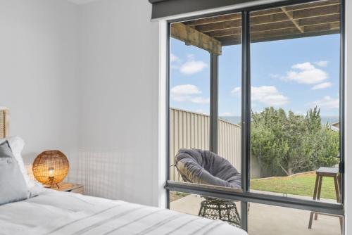 a bedroom with a bed and a large window at Seaview at the Bay - Wi-Fi - Oceanview - Near Beach - No Linen Included in Encounter Bay